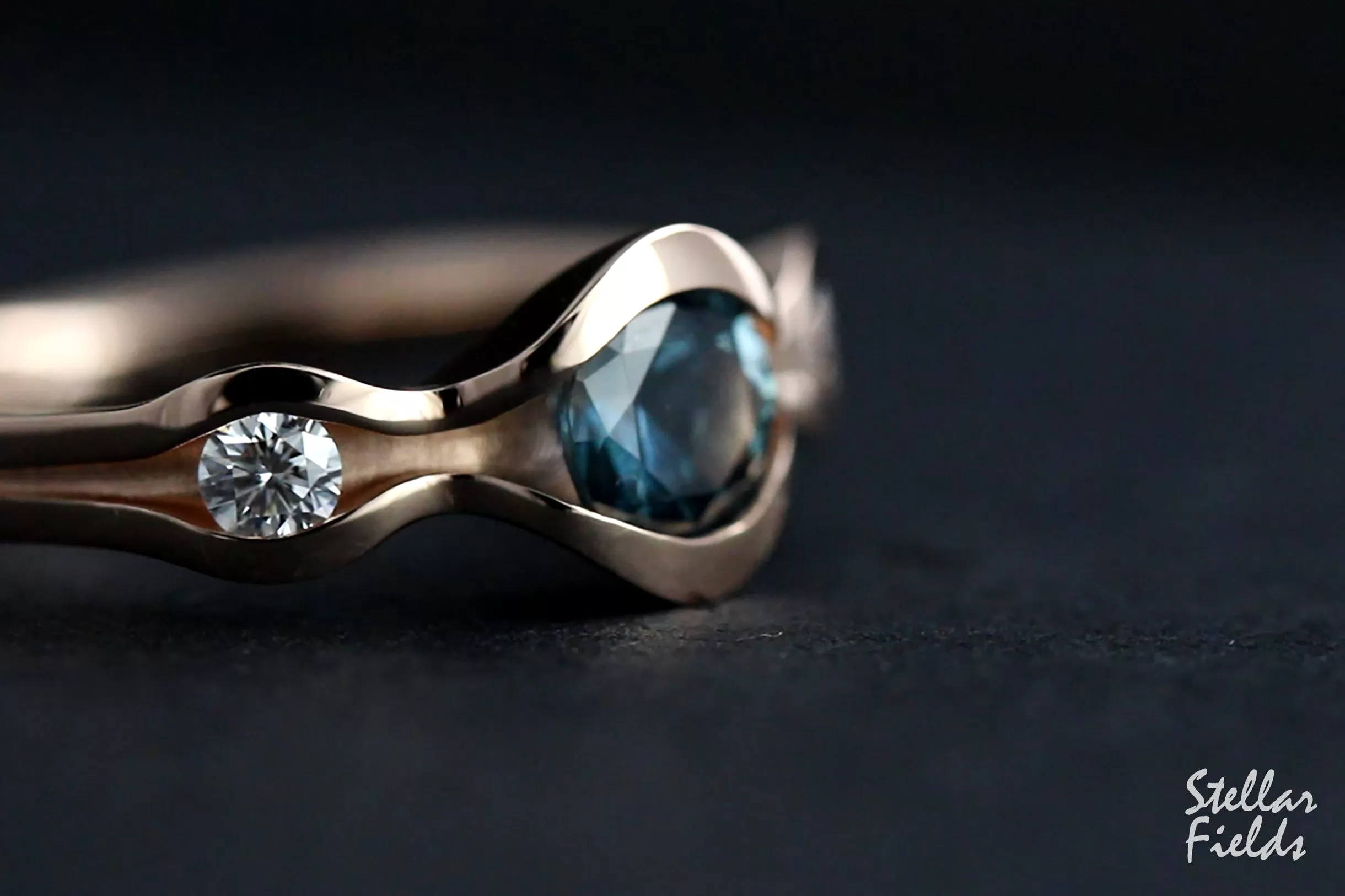 Three Stone Wave Engagement Ring with Teal Montana Sapphire & Canadian Arctic Diamonds