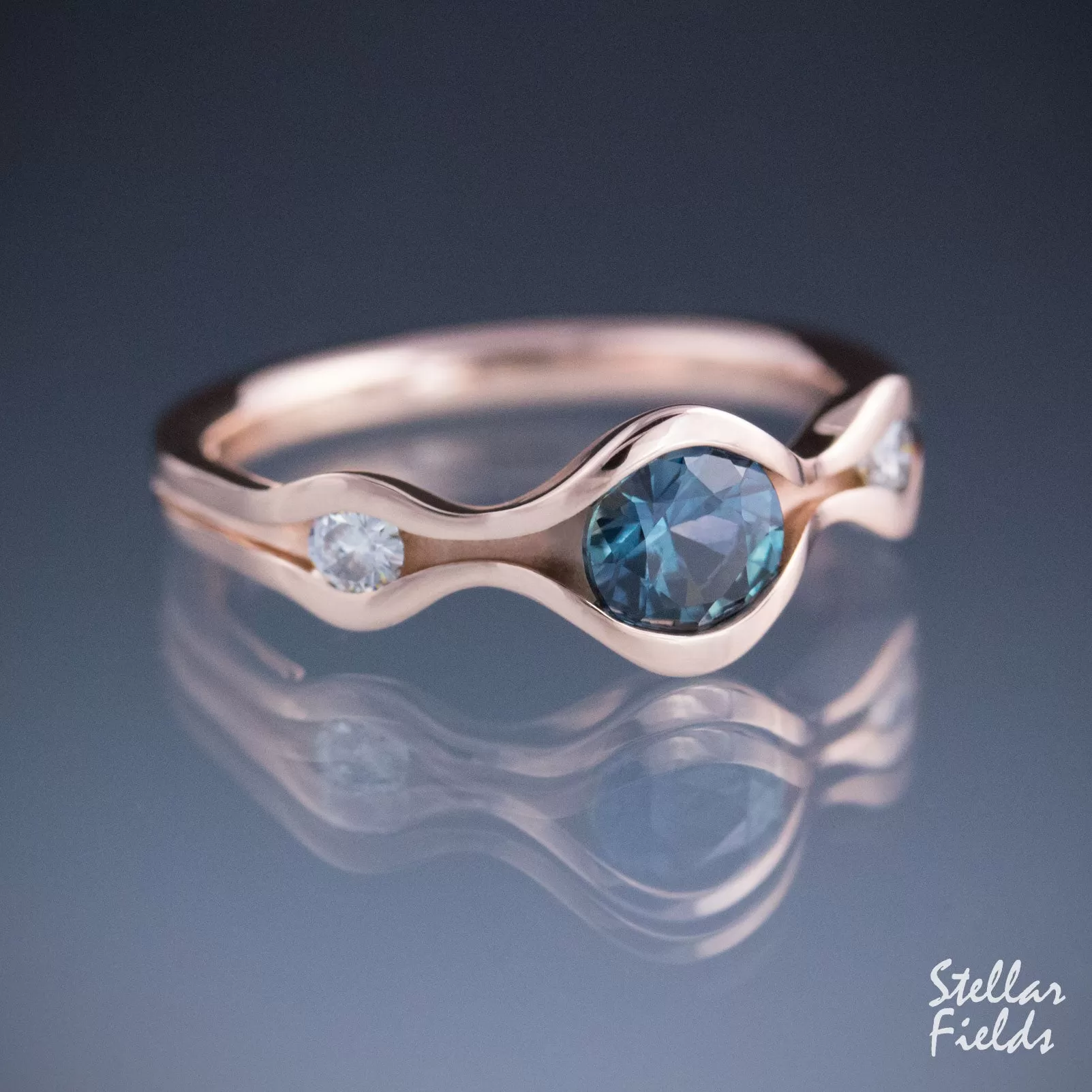 Three Stone Wave Engagement Ring with Teal Montana Sapphire & Canadian Arctic Diamonds